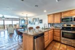 breakfast bar with granite counters, stainless steel appliances, decorative tile back splash